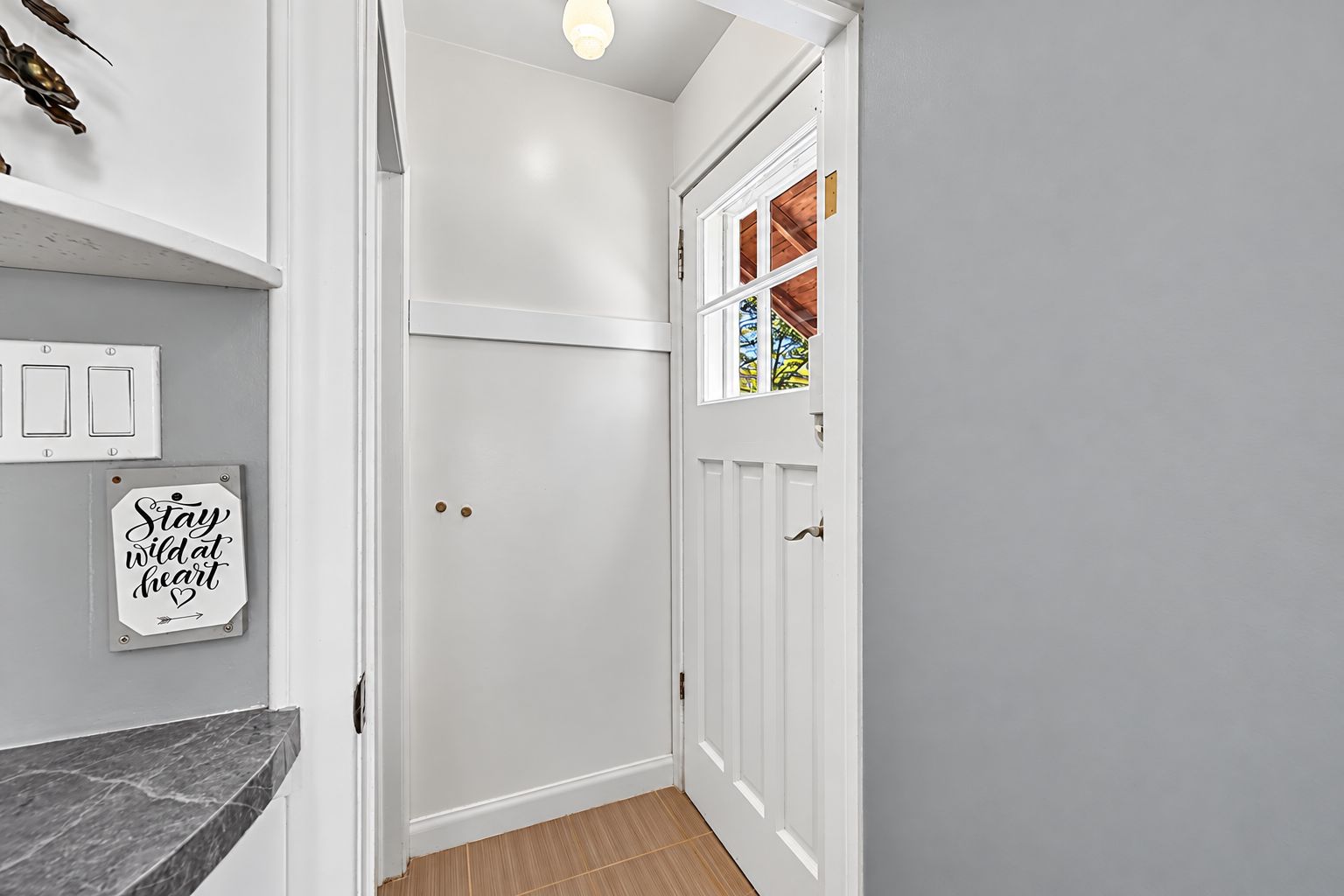 Bright Farmhouse Entryway with “Stay Wild” Sign