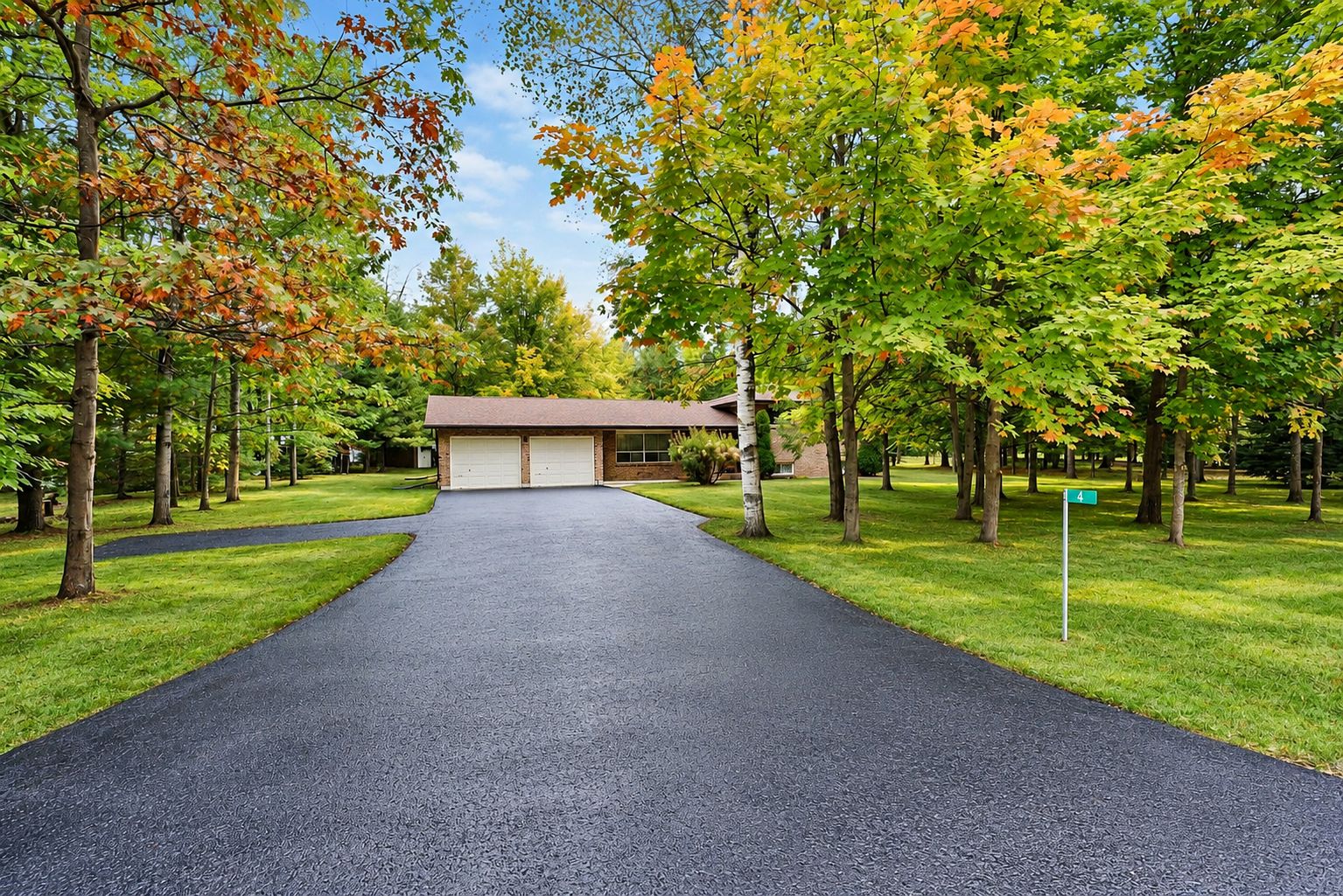 Pristine driveway, lush lawn, autumn charm